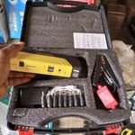 50800mAh car jump starter power bank with cables and built-in torch on white background.